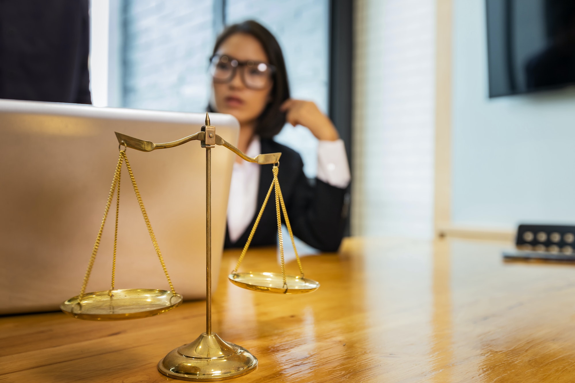 Scales and lawyer working on a laptop. Lawyer office. advice and justice concept.